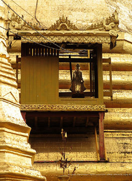 A tiny protective Buddha Image at the Sule Pagoda main dome