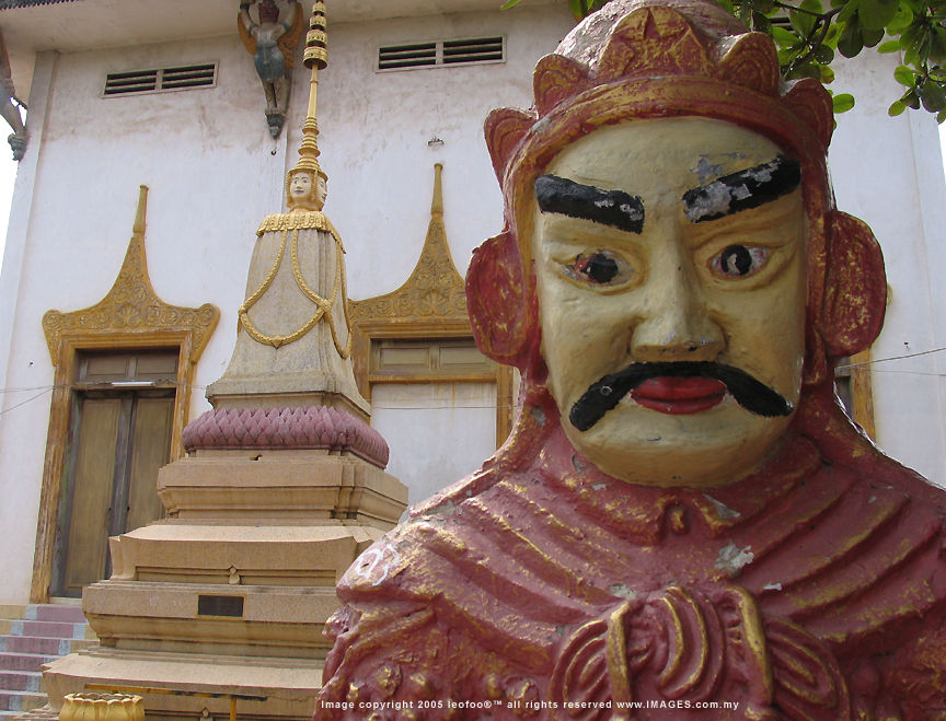 An explosive view of a typical Cambodian guarding figure outside the temple