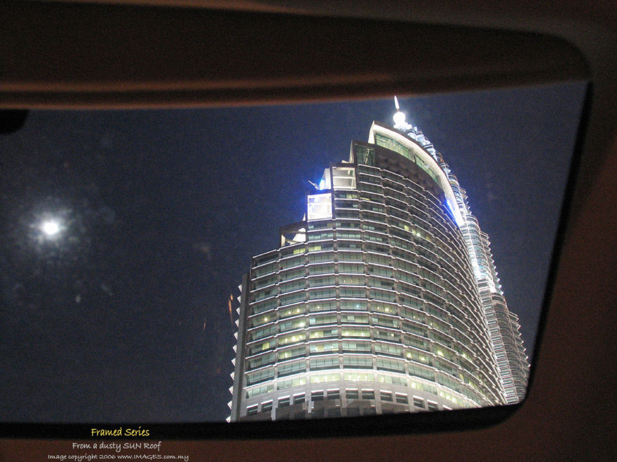 a internal view shot from a dusty moon roff of my car on Petronas Twin Towers - KLCC from the highway
