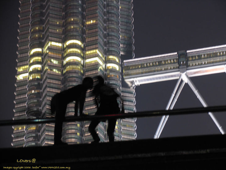 A candid shot of  a piar of lovers at the sky bridge at  Petronas Twin Towers, KLCC