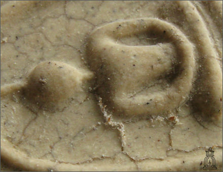 Details of depostion on a typical Soomdet Buddhist amulet