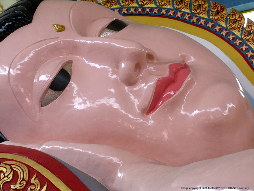 The section view of the facial expression of the huge reclining Buddha at Wat Chaiyamangalaram Thai Temple in Penang Island