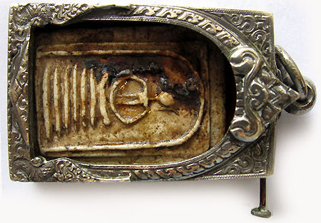 An old Thai amulet (Soomdet Keschaiyo) cased inside a classic old aged amulet case/frame in silver