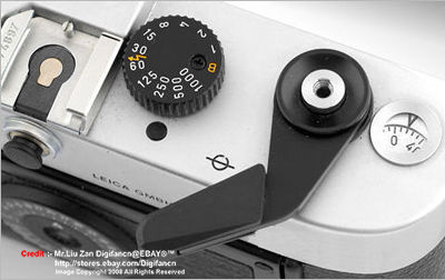 Black fittings on film advance lever, shutter speed dial on top plate on a Leica M6 Panda 