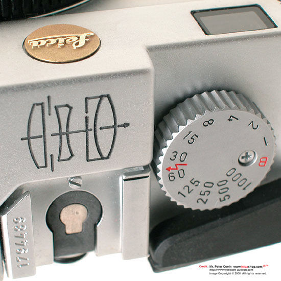 Close-up view of Leica M6G features, optical illustration engraved and brassy gold Leica roundel / logo