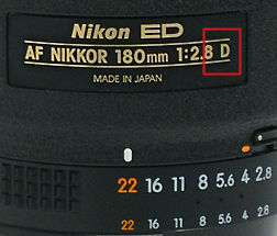 The lens data plate of the  AF Nikkor 180mm f/2.8D IF ED telephoto lens whcih shows the D designation lens type