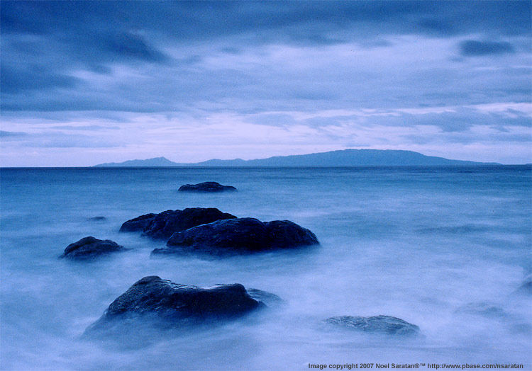 rocks & maricaban island by Noel Saratan
