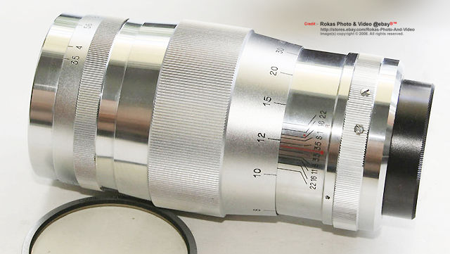 Side view of an all chrome Canon 135mm f/3.5 telephoto lens
