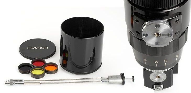 Close up view of rangefinder  M39 400mm f/4.5 telephoto lens , tripod socket, cable releases, filters, lens cap and hood.