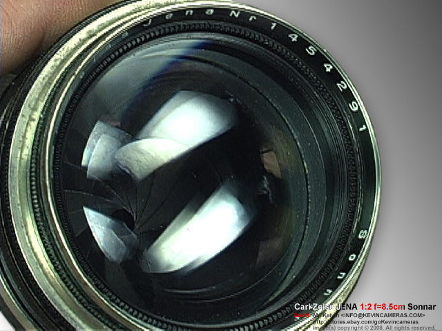 Lens element and reflection of Rangefinder black ring version Contax Carl Zeiss JENA Sonnar 1:2 f=8.5cm  (85mm f/2.0) Chrome Telephoto lens  front view