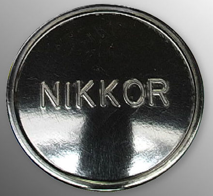 A large NIKKOR old style lettering on the  front cap during the Nikon rangefinder days