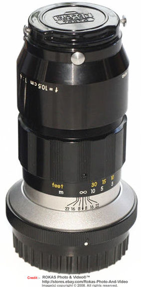 Front old lens Nippon kogku lens cap design with reversible metal lens hood for a view of a F mount version of the Nikkor-T 1:4 f=10.5cm (Nikkor-T 105mm f/4.0 non Ai Nikkor) telephoto lens for Nikon reflex SLR camera system