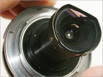 The exposed lens element at the rear section of the 21mm f/4.0 Nikkor-O