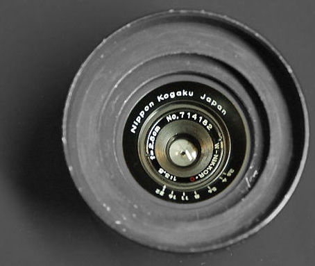 A black version of the W.Nikkor-C 2.8cm f/3.5 (28mm f/3.5) RF rangefinder wideangle lens with dedicated lens hood attached.