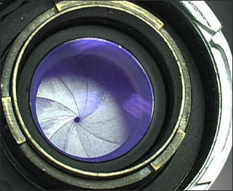 Rear lens mount with reflective lens coating on a Contax Mount Nikkor-P telephoto lens 