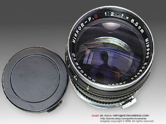 Black lens barrel model of a Nippon Kogaku (Nikon) Nikkor-P 1:2 f=8.5cm telephoto lens for Nikon rangefinder cameras w/black, metal lens cap