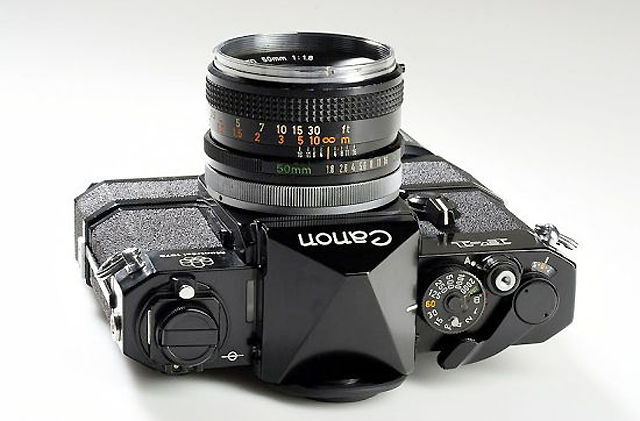 Canon F-1 Professional SLR camera with special serial number of 1974 and Montreal 1976 top plate, 
Canon FD 1.8/50mm, Montreal cap, motor-drive unit with power-grip. Approx. Year 1974 
