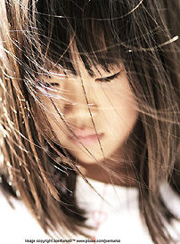 Sunny girl in windy sunshine